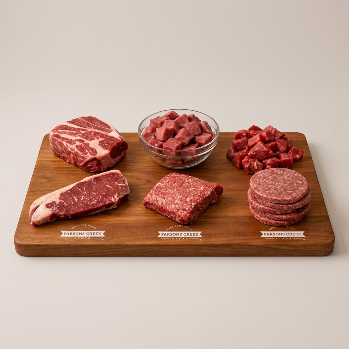 Build-your-own bundle: assorted raw beef cuts on wooden board, includes Parsons Creek labels