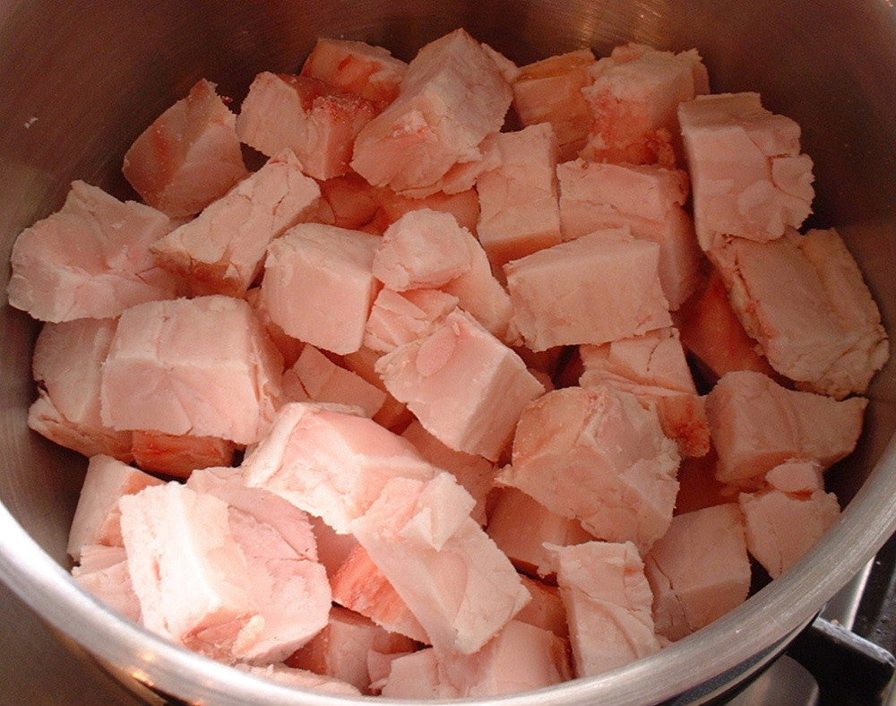 Beef suet chunks, pale pink pieces in a metal bowl