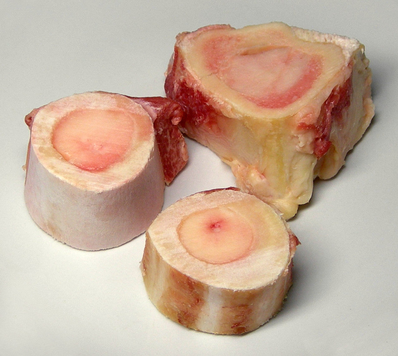 Bone marrow bones: three cross-section marrow bones with exposed pink marrow