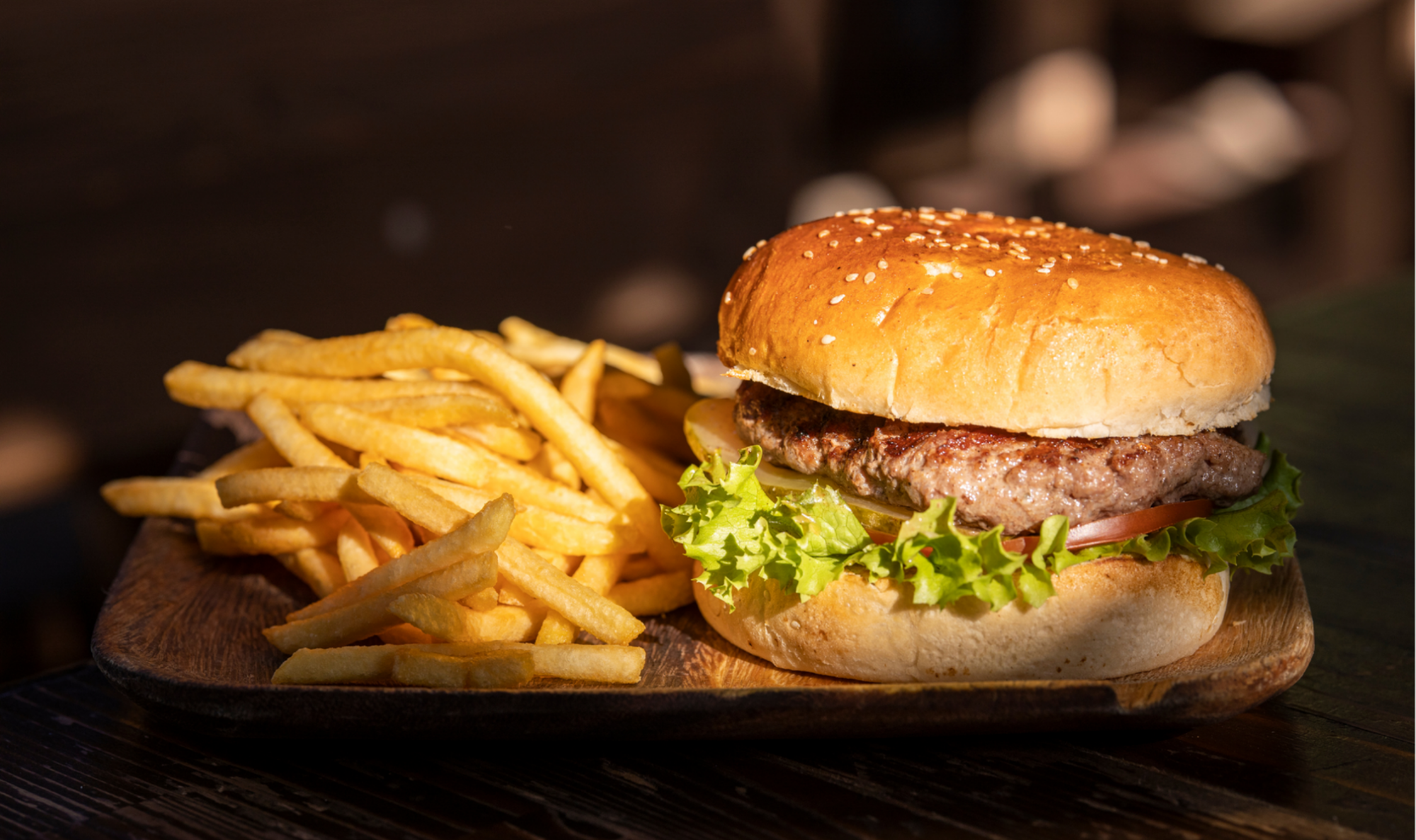 Ground pork burger with lettuce and tomato, served with fries