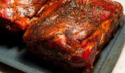 Roasted pork butt with dark seasoned crust, browned edges and visible fat