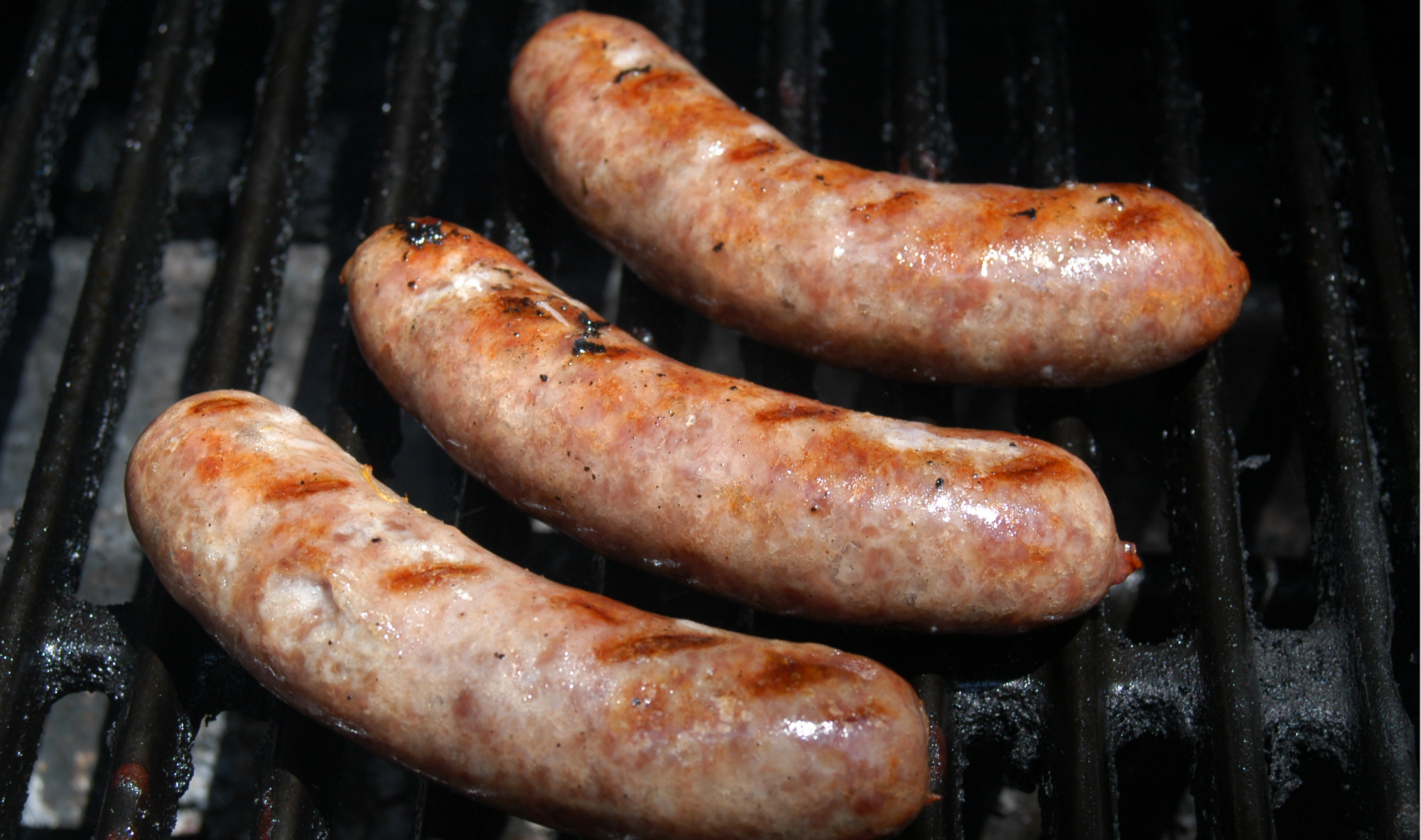 Pork brats sausages, three grilled links with browned casings
