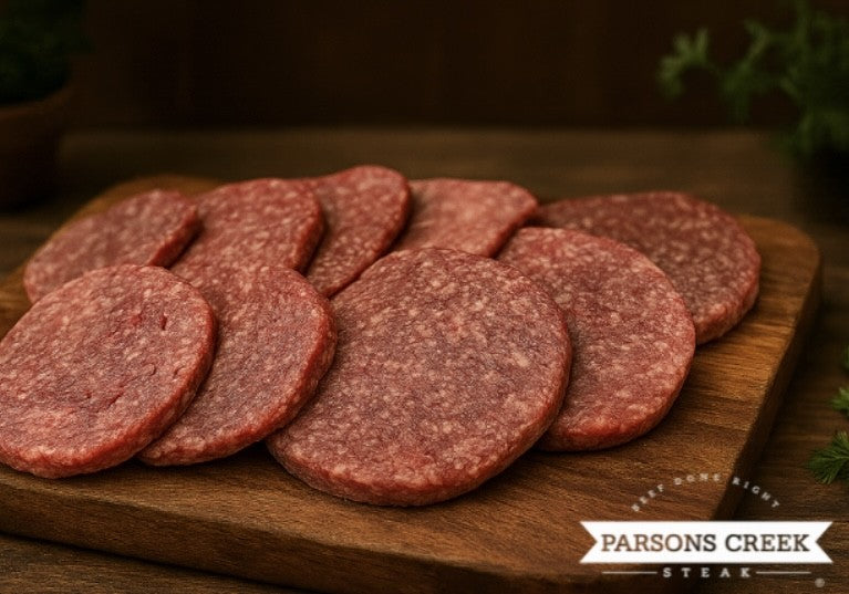 Beef steak burger patties on a wooden serving tray