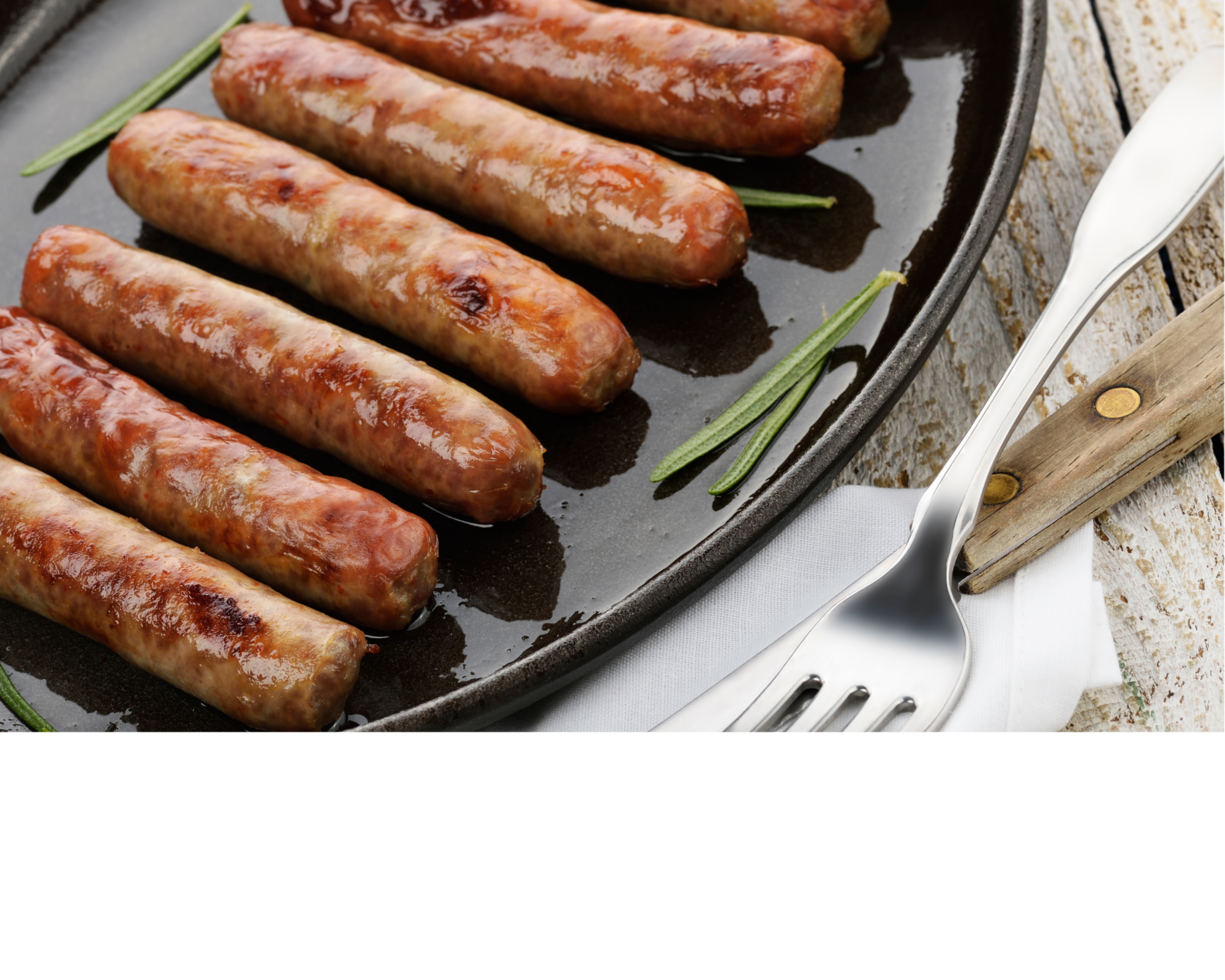 Cooked sausage links on a baking tray with rosemary sprigs